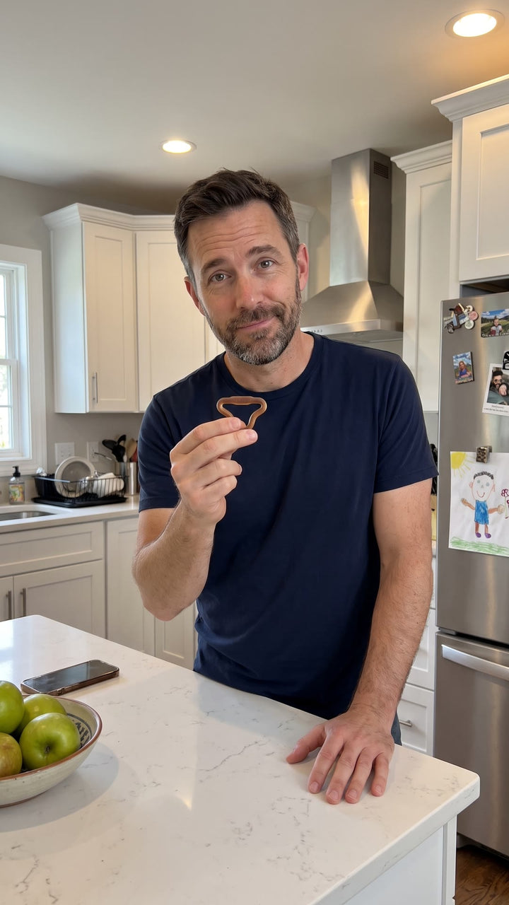 Man in his kitchen holding a Firm Sedgeia ring between two fingers